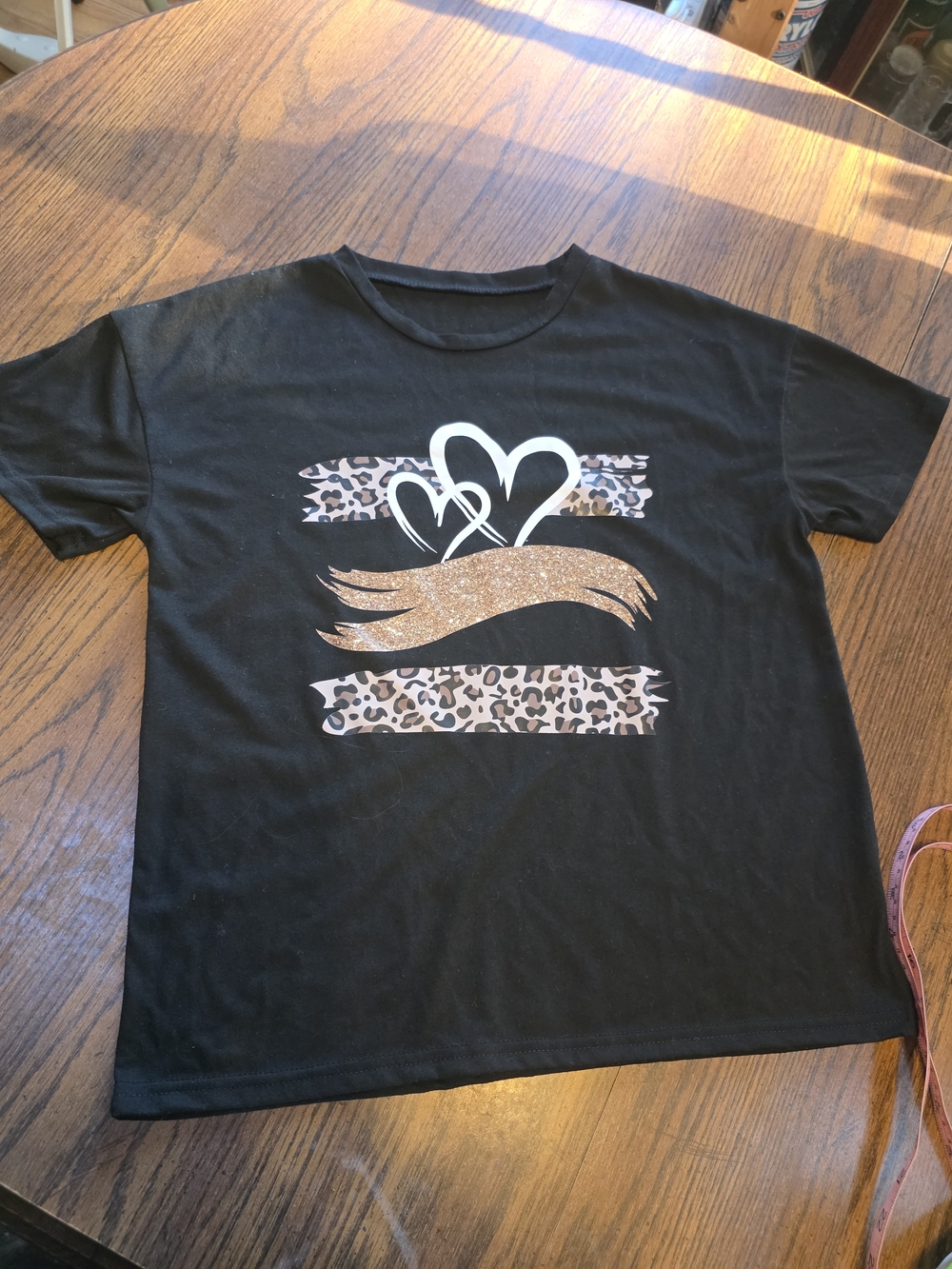 SHEIN Black Tee with Leopard Stripes, White Hearts & Gold Glitter Accent